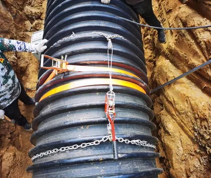 Electrofusion band secured around a large pipe in a trench