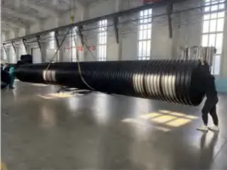 Person beside a large-diameter PE structured-wall pipe