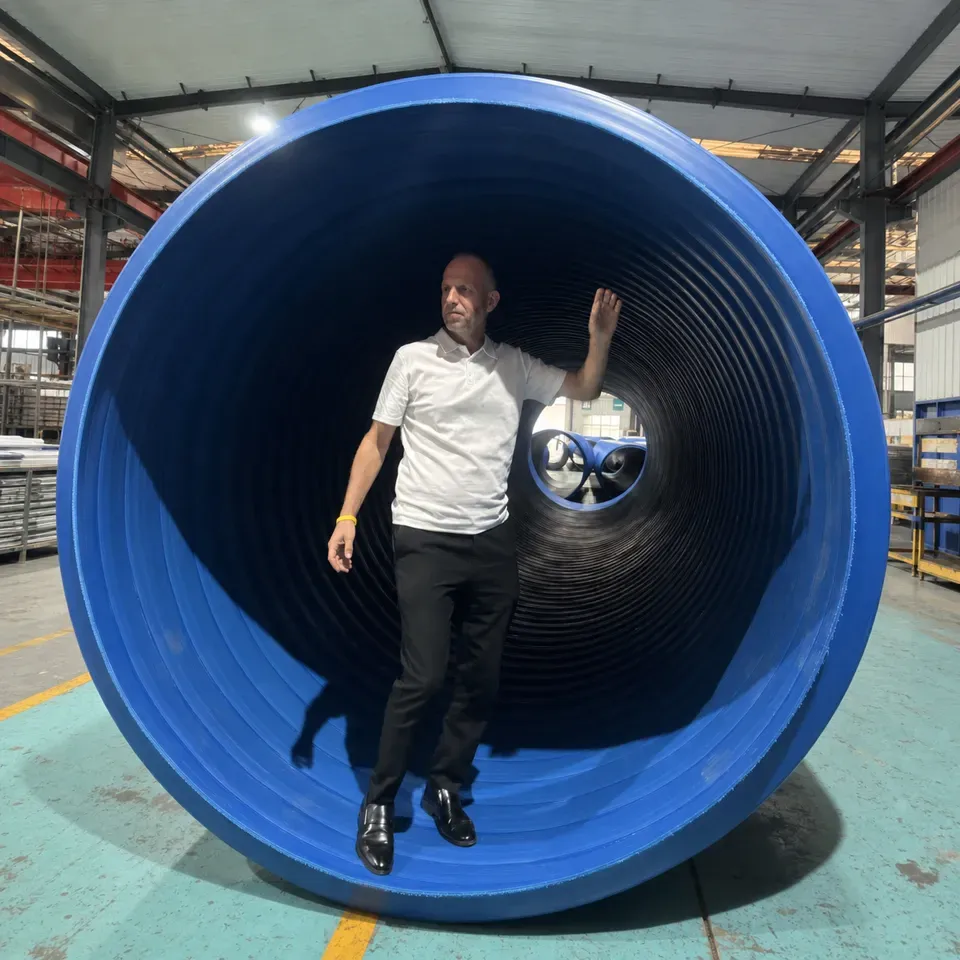Person standing inside a large-diameter blue HDPE structured-wall pipe