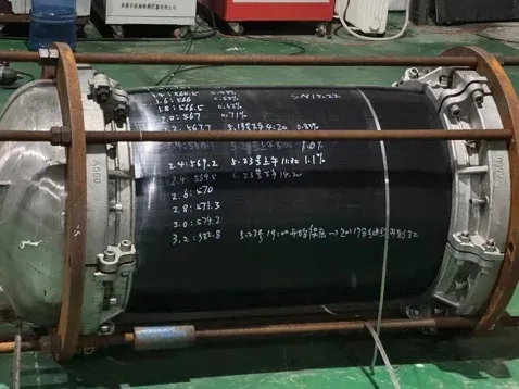 DN560 pipe section mounted in a pressure-test rig with end caps